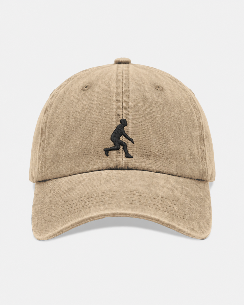 The Plastic Hat — a stone washed-cotton dad cap with the Plastic Ultimate figure embroidered on the front